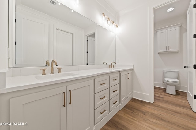 bathroom featuring vanity, hardwood / wood-style floors, and toilet