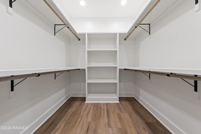 walk in closet with hardwood / wood-style flooring