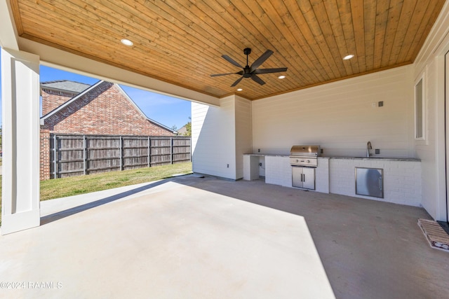 view of patio / terrace with an outdoor kitchen, area for grilling, and ceiling fan