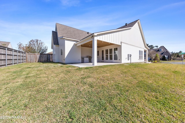 back of house with a yard and a patio area