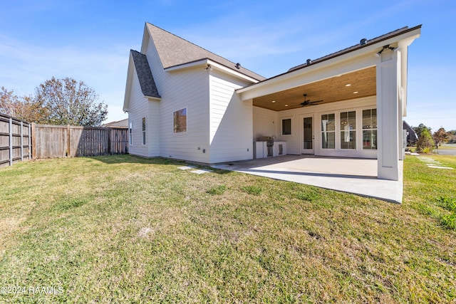 rear view of house featuring a yard, a patio area, and ceiling fan