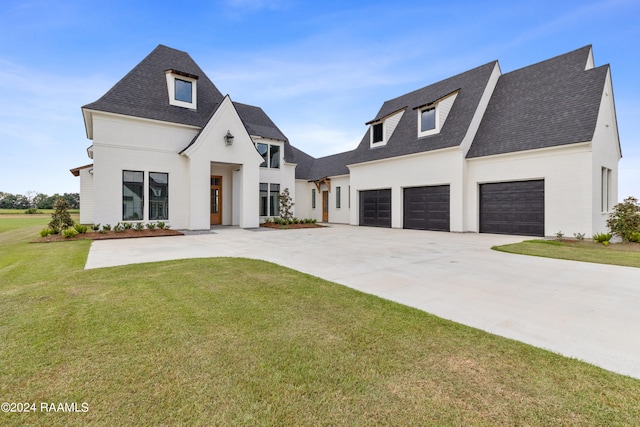 view of front facade with a front yard and a garage