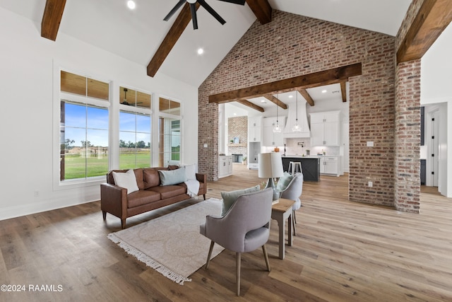 living room with high vaulted ceiling, beamed ceiling, ceiling fan, and light hardwood / wood-style floors