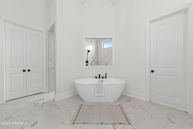 bathroom with a washtub and tile patterned flooring