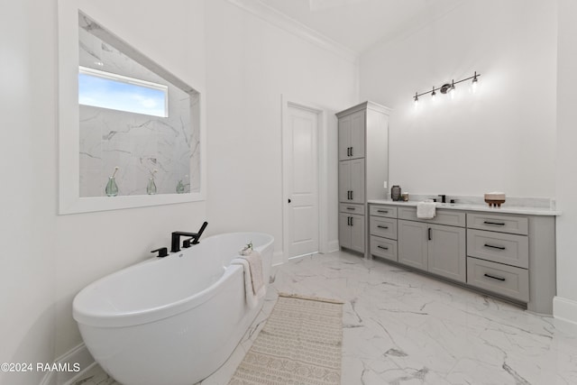 bathroom featuring ornamental molding, tile patterned floors, vanity, and a bathing tub