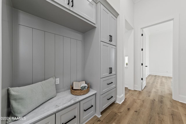 mudroom with light hardwood / wood-style floors