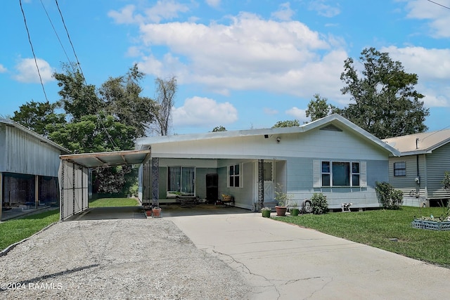 view of front of property with a carport and a front lawn