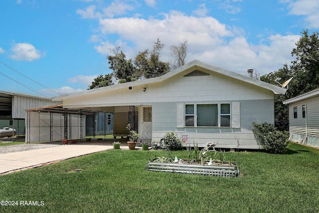 view of front of property with a front lawn and a carport