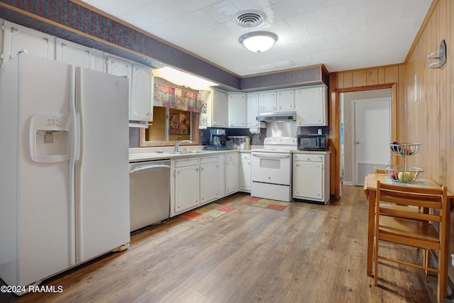 kitchen featuring white appliances, sink, light wood-type flooring, and white cabinets