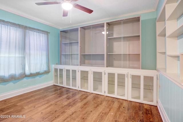 spare room featuring hardwood / wood-style flooring, ornamental molding, and ceiling fan