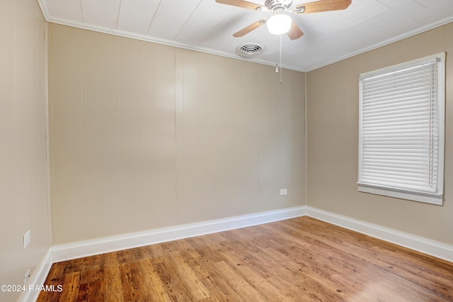 unfurnished room with crown molding, hardwood / wood-style floors, and ceiling fan