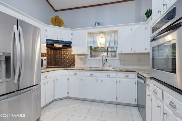 kitchen with white cabinets, stainless steel appliances, sink, and decorative backsplash