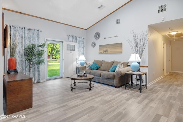 living room featuring light wood-type flooring, ornamental molding, and high vaulted ceiling