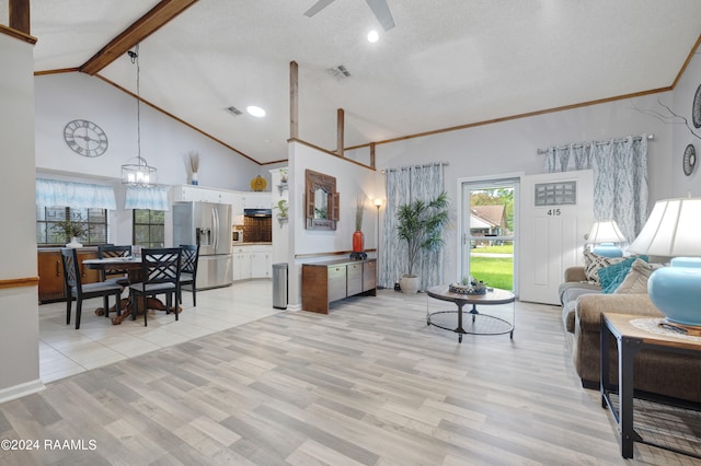 living room with a textured ceiling, ceiling fan with notable chandelier, high vaulted ceiling, and light hardwood / wood-style floors