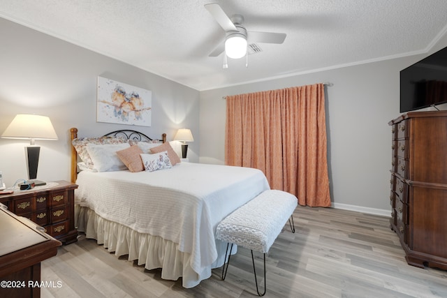 bedroom with light wood-type flooring, ceiling fan, crown molding, and a textured ceiling