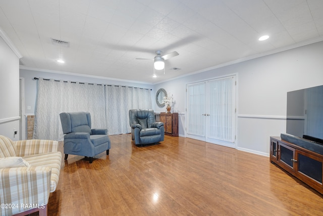 sitting room featuring crown molding, hardwood / wood-style floors, and ceiling fan