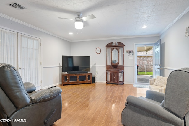 living room with hardwood / wood-style floors, ceiling fan, and ornamental molding