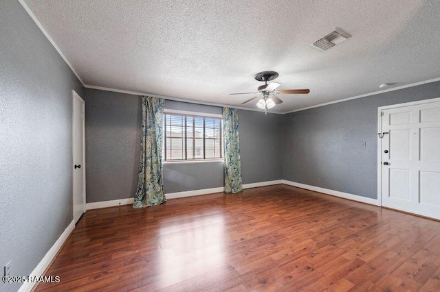 spare room featuring hardwood / wood-style flooring, ceiling fan, crown molding, and a textured ceiling