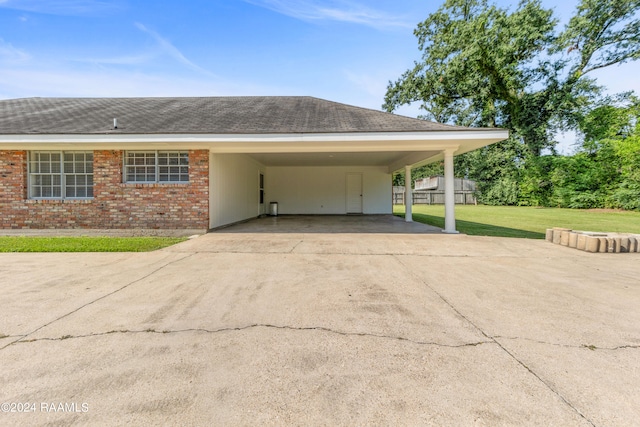 garage with a lawn and a carport