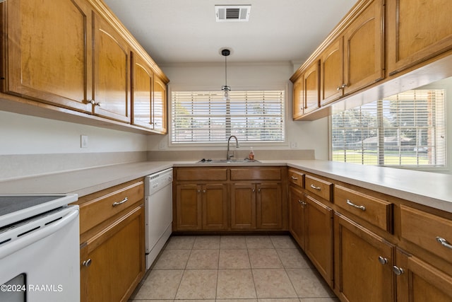 kitchen with a healthy amount of sunlight, dishwasher, light tile patterned floors, and sink