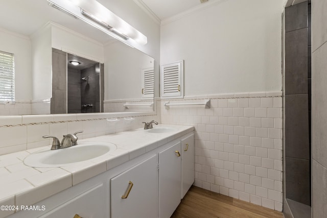 bathroom featuring crown molding, hardwood / wood-style floors, a shower, tile walls, and vanity