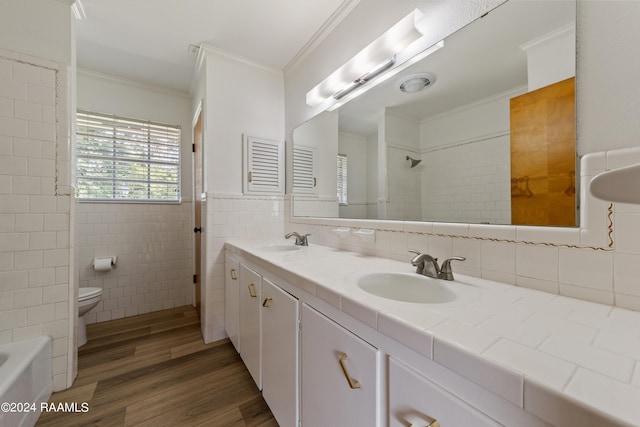 bathroom featuring hardwood / wood-style flooring, crown molding, toilet, tile walls, and vanity