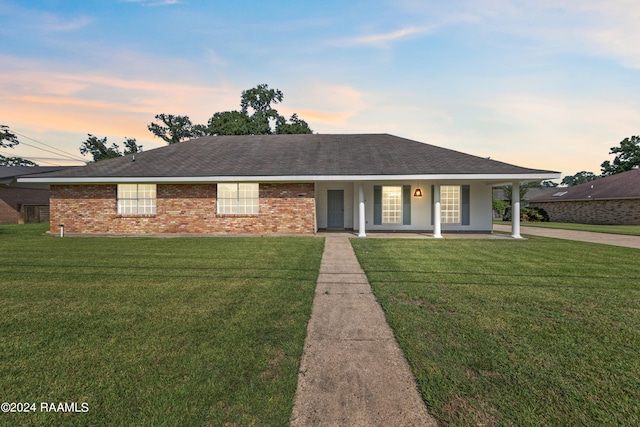 single story home with a yard