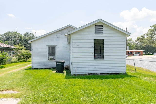 view of side of home with a lawn