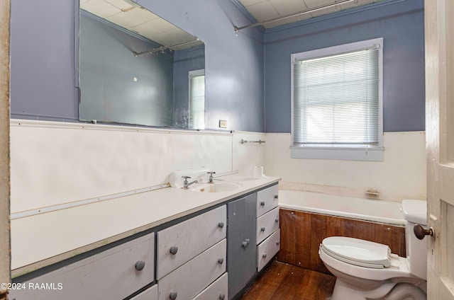 bathroom featuring vanity, a wealth of natural light, toilet, and hardwood / wood-style flooring