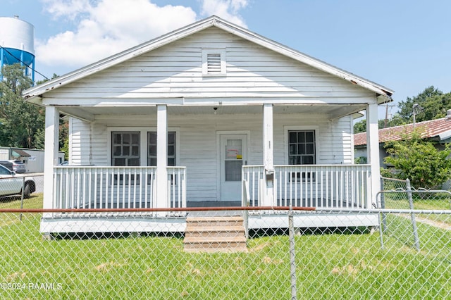 bungalow-style home featuring a front yard and a porch