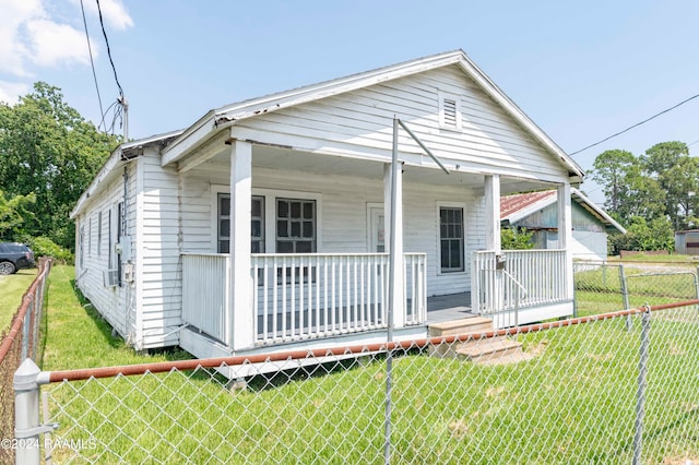 bungalow-style house with a front yard and a porch