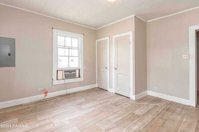 unfurnished bedroom featuring electric panel, light wood-type flooring, cooling unit, and ornamental molding