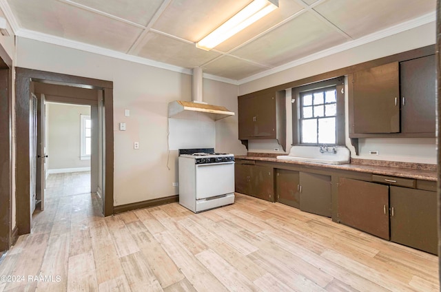 kitchen with dark brown cabinets, light hardwood / wood-style floors, sink, wall chimney range hood, and white gas range