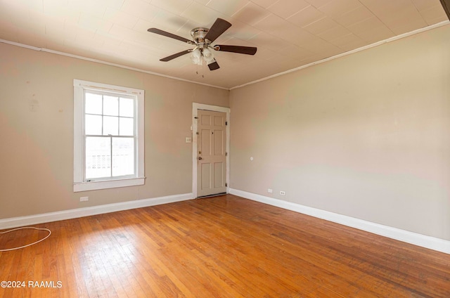 unfurnished room with ceiling fan, light hardwood / wood-style flooring, and ornamental molding