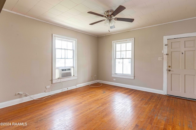 unfurnished room with cooling unit, hardwood / wood-style floors, and a healthy amount of sunlight