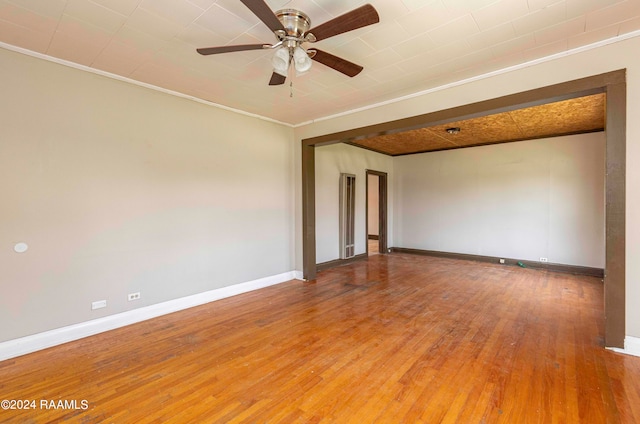 unfurnished room with ceiling fan, ornamental molding, and hardwood / wood-style floors