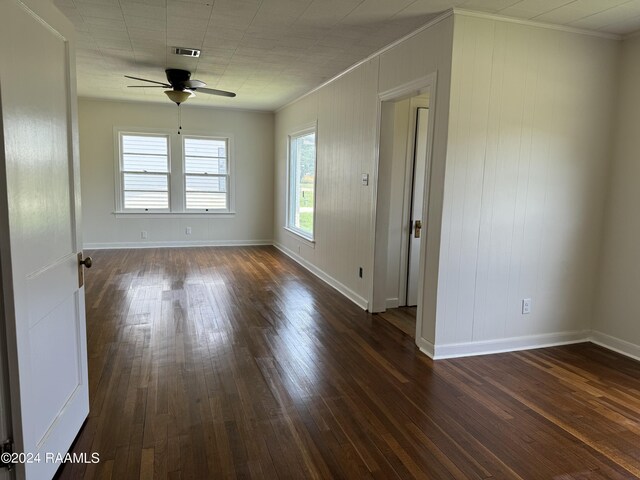 unfurnished room featuring ceiling fan, wood-type flooring, and ornamental molding