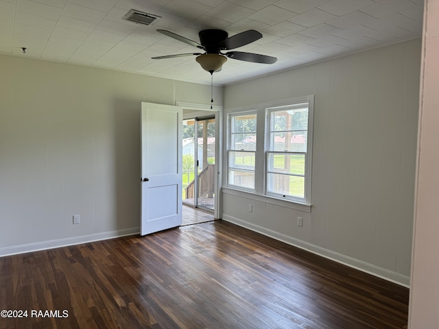 unfurnished room with visible vents, dark wood finished floors, baseboards, and ceiling fan