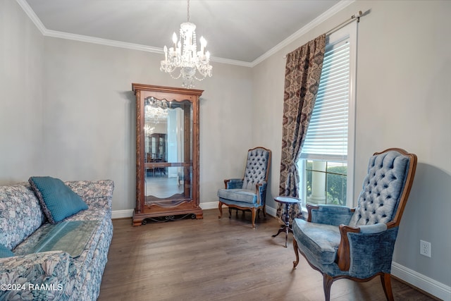 sitting room featuring hardwood / wood-style flooring, an inviting chandelier, and crown molding