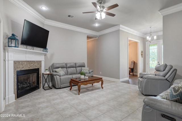 tiled living room with crown molding and ceiling fan with notable chandelier