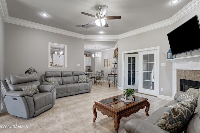 tiled living room featuring crown molding and ceiling fan with notable chandelier