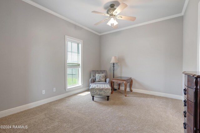 living area featuring ceiling fan, plenty of natural light, light carpet, and ornamental molding