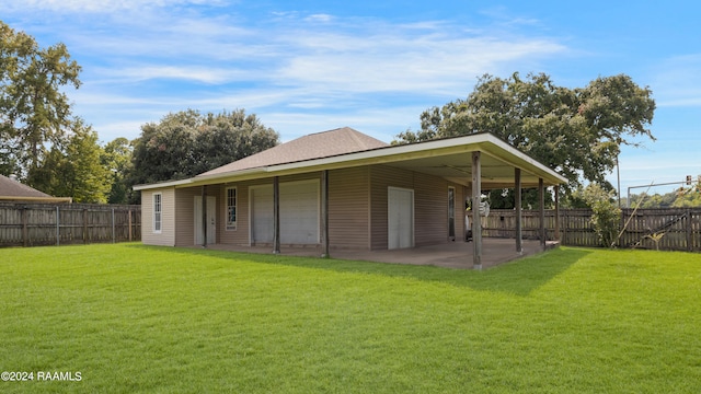 rear view of house with a patio and a lawn