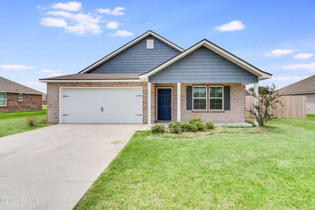 view of front of property featuring a garage and a front lawn