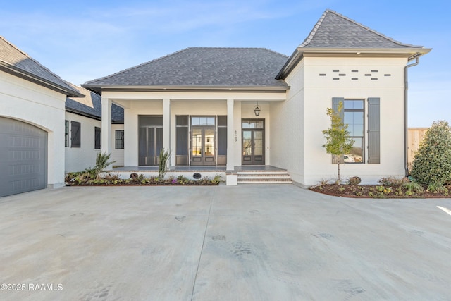 view of front of home featuring a porch and a garage