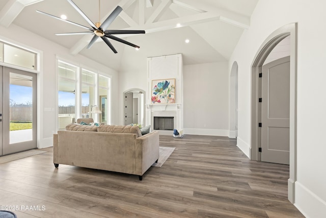 living room featuring beam ceiling, high vaulted ceiling, and hardwood / wood-style floors