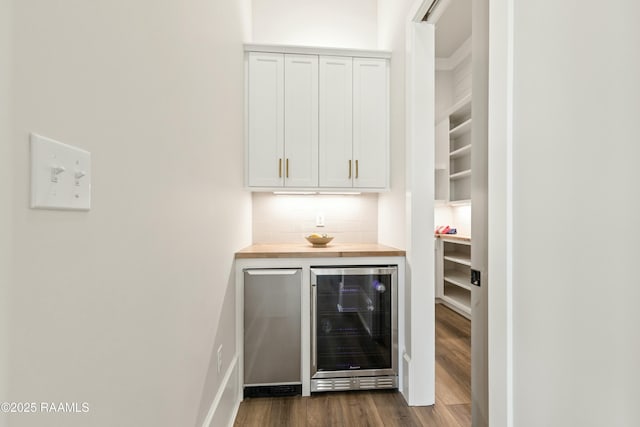 bar with white cabinets, wood counters, backsplash, dark hardwood / wood-style floors, and wine cooler