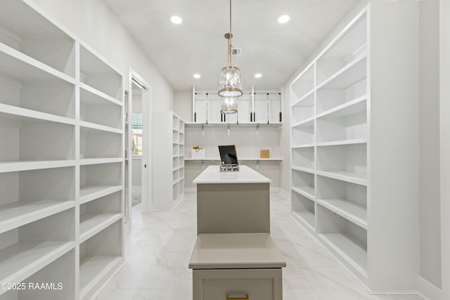 walk in closet featuring an inviting chandelier