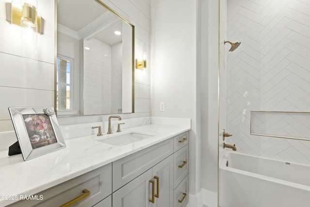 bathroom featuring vanity and tiled shower / bath