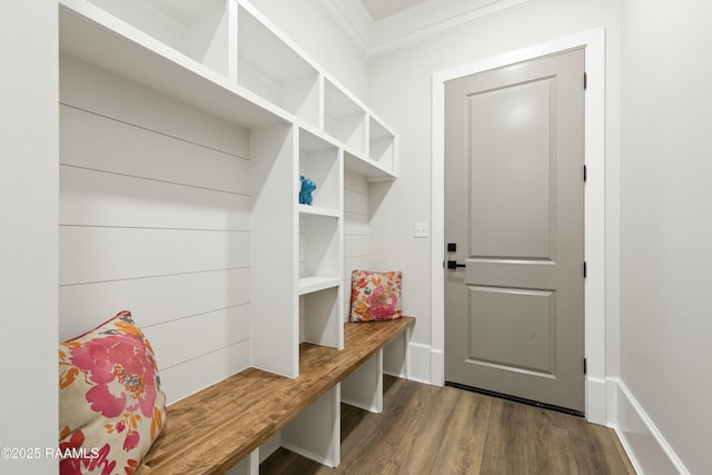 mudroom with dark wood-type flooring and ornamental molding